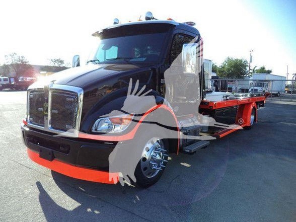 Kenworth T280 tow truck with a black cab and orange accents, long orange flatbed; visible front grille, headlights, cab mirrors, and side steps.