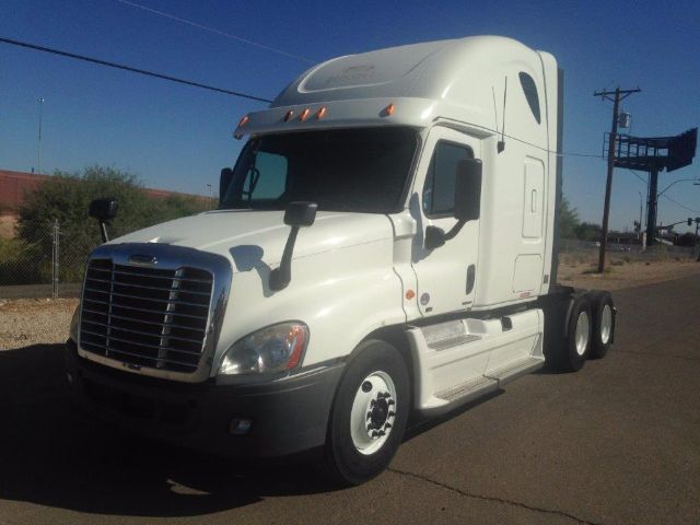 White Freightliner Cascadia semi-truck with sleeper cab, front grille and headlights visible, no legible labels or warning signs.