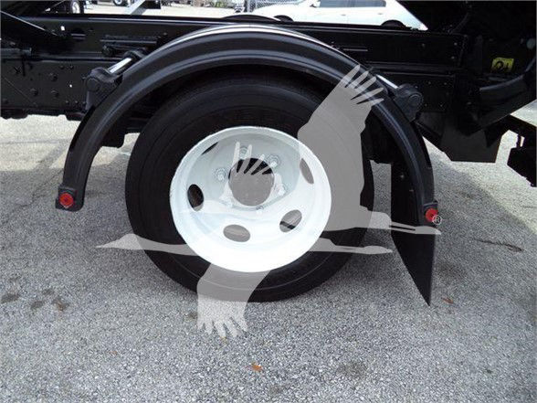 Isuzu NRR rear wheel with wheel guard showing spare mounting and hub area.