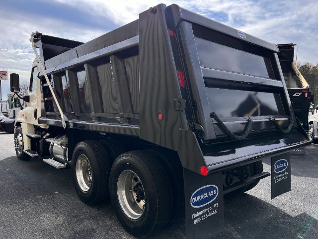 Dump truck bed of 2019 Freightliner Cascadia 125 rear and side view with black dump bed and dual rear wheels.