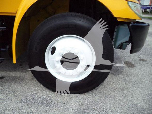 Vehicle wheel well of a yellow 2018 International DURASTAR 4300 with front fender and tire visible; no other legible text visible in this crop.