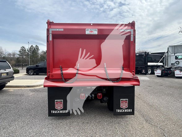 Rear view of a red dump truck bed mounted on a Kenworth T480 chassis. There is a white label on the upper center of the tailgate, and black mud flaps with white TruckWorx logos.