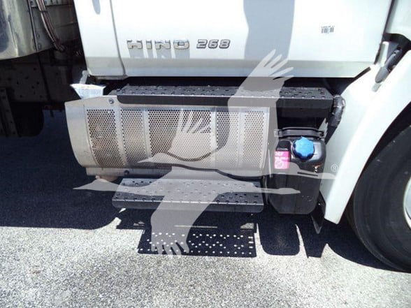 Hino 268 truck side view showing fuel tank with blue cap, step, and perforated metal splash guard; 'HINO 268' badge on cab.
