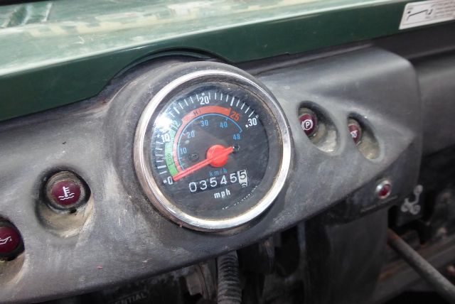 Dashboard gauge cluster showing speedometer with 0-60 mph and odometer reading 035455; Kawasaki KAF950G utility vehicle dashboard with warning lights.