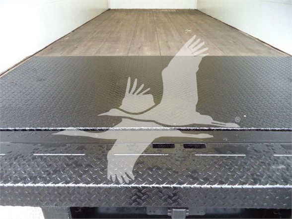 Ford E-450 truck bed with diamond plate and loading platform; faint logo watermark across image.