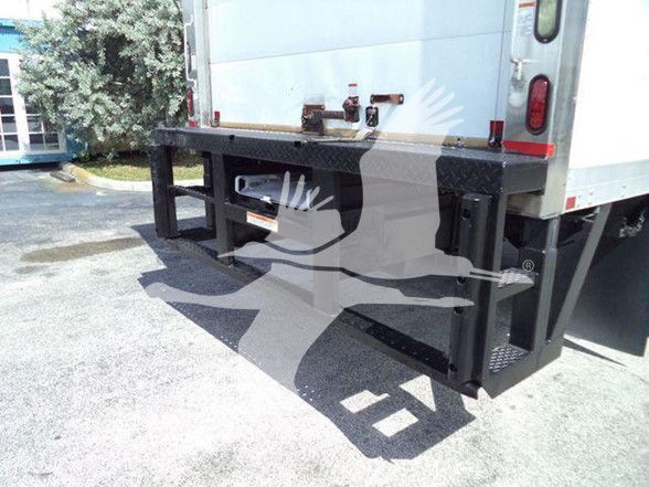 Rear view of a refrigerated truck with a heavy-duty black steel rear bumper guard and tailgate area visible.