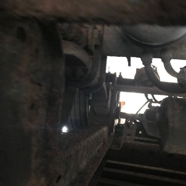 Underframe view of a used 1998 Pines dry van trailer showing structural members and wheel area.