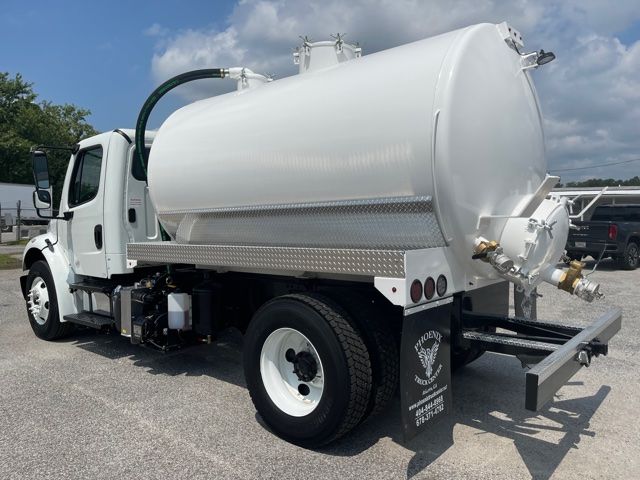 Side view of a 2015 Freightliner M2 vacuum/sewer truck with a large cylindrical tank, rear hose connections, and mud flaps.