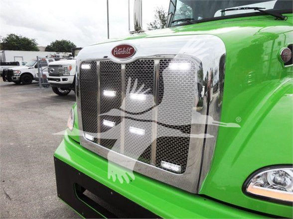 Peterbilt 337 front grille with chrome grille and green cab. Visible text includes Peterbilt emblem on the hood.