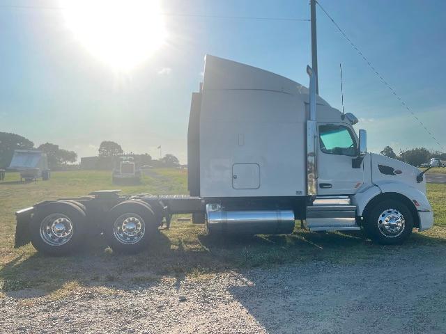 Peterbilt 579 conventional sleeper truck side view showing cab, rear axles, fuel tanks, and chassis.