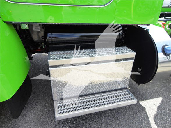 Peterbilt truck entry steps with diamond plate metal step and green truck body visible.