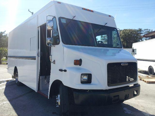 Workhorse p42 step van side/front view showing cab area and cargo box with open driver's door.