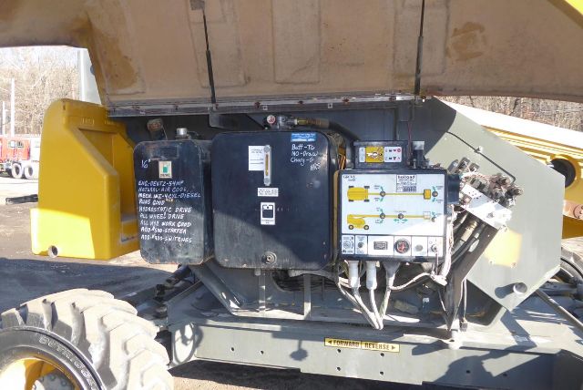 Grove T60 crane side view showing control panels and hydraulic components under open cover.