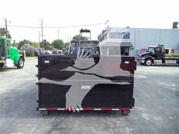 Truck dump bed with graphic of a bird silhouette on black background.