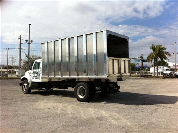 Dump body truck in-service showing a 16 ft Advanced Fabricators dump bed mounted on a white cab chassis.