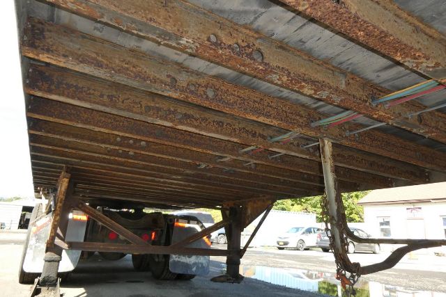 Great Dane trailer undercarriage with rusted joists and support beams, undercarriage view showing trailer structure.