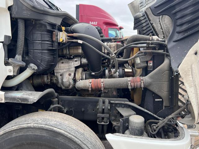 Cascadia engine bay showing turbocharger, intercooler piping, hoses, and coolant reservoir.