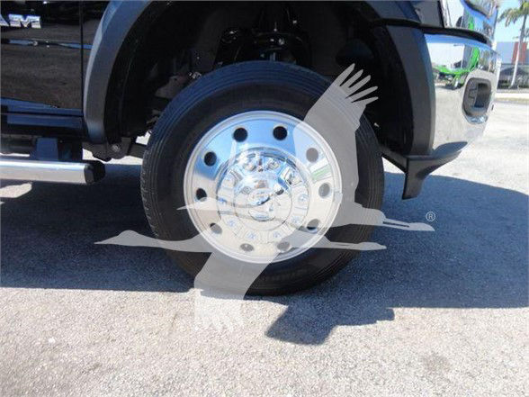 Ram 5500 SLT wheel and front fender with chrome hubcap, partial grille, and tire visible; watermark overlay on image.