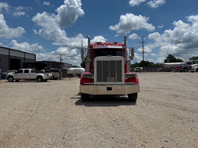 Peterbilt 379 truck front view in a gravel lot.