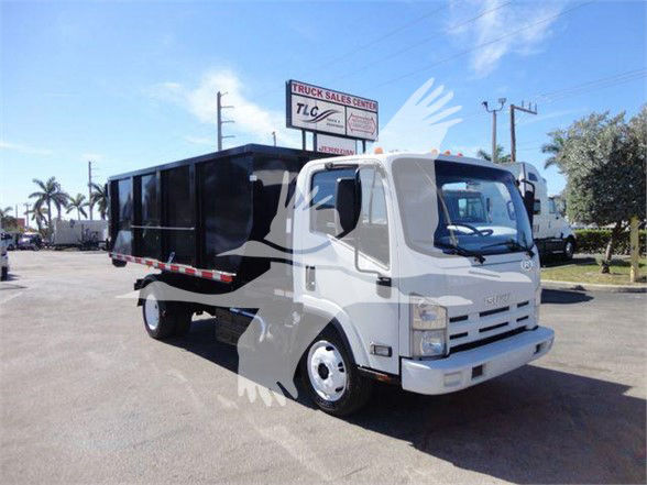 Isuzu NPR/NRR series truck with black dump bed, front view showing cargo body and cab, in a dealership lot.