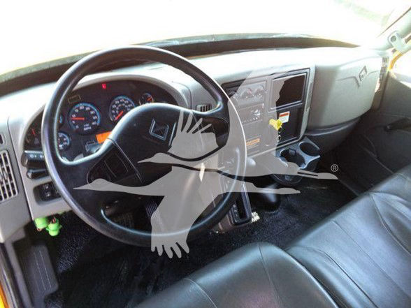 Dashboard and steering wheel of a 2019 International DURASTAR 4300 cab interior showing instrument cluster and center console.