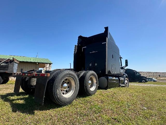 Peterbilt 579 conventional sleeper semi-truck chassis and cab side view with dual rear axles.