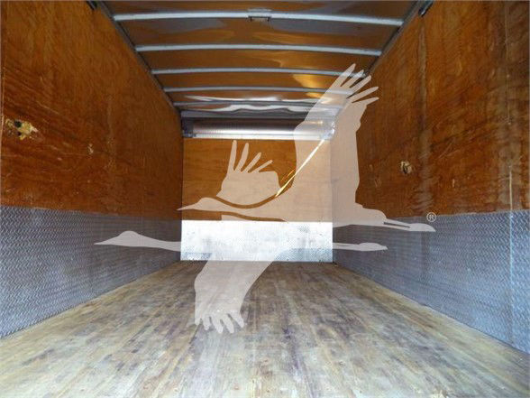 Isuzu box truck cargo area with wooden floor and metal sidewalls, empty interior.