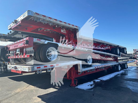 Manac Legend Combo Drop Deck trailer in red with expandable drop deck and multiple axles, showing reflective tape and rear underride guard.