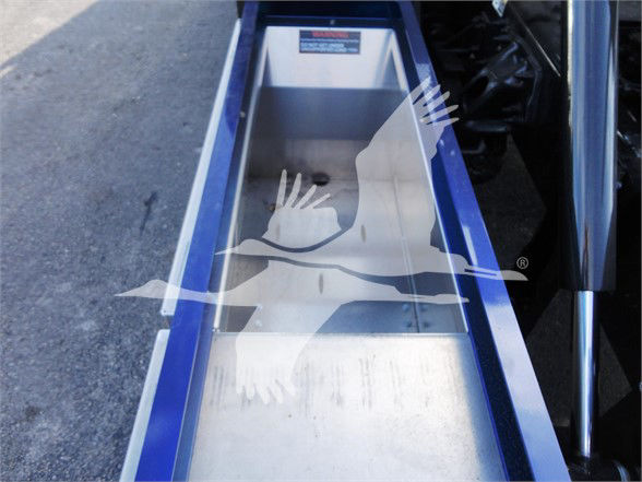 truck bed step with metallic silver surface and blue frame. No legible text visible on the part in view.