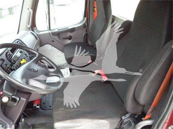 Truck interior cabin showing steering wheel and driver seat with seat belt. Overlay watermark of a bird silhouette.