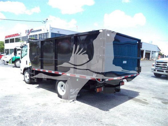Isuzu NRR dump truck with black and gray bed, side view showing cargo body and rear undercarriage.