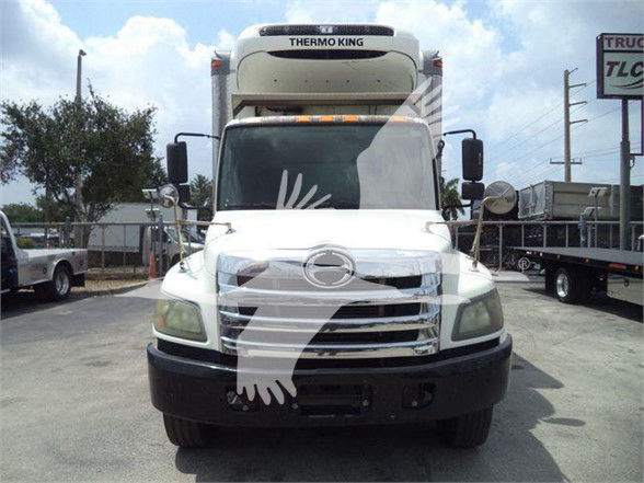 Thermo King reefer truck cab front view with white body and black bumper.
