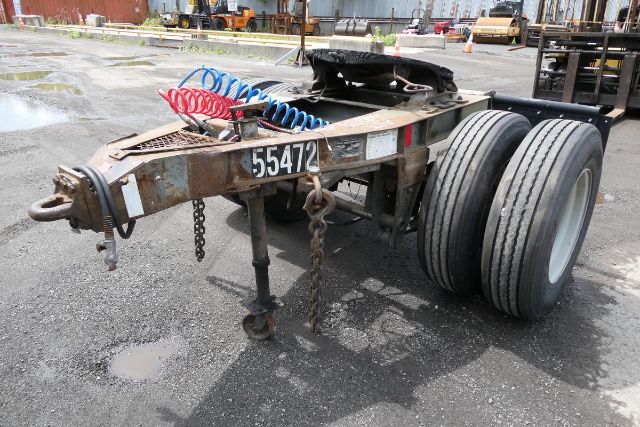 Fruehauf ELFI trailer chassis showing dual rear tires, numbered 55472, with coiled air lines and hitch hardware.