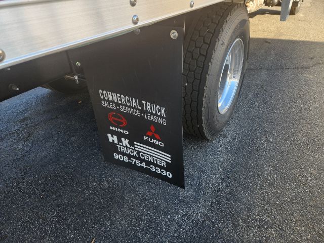 Truck mud flap showing text: COMMERCIAL TRUCK SALES SERVICE LEASING HINO FUSO TRUCK CENTER 908-754-3330
