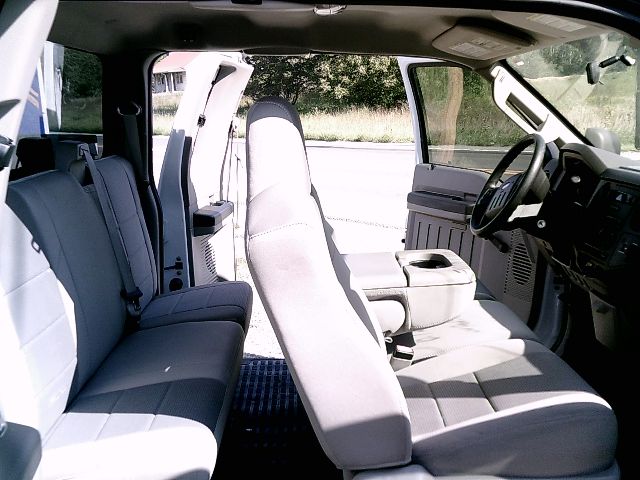 Ford F-250 Super Duty interior showing front bench seat and driver area with gray seating and dashboard.