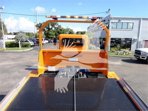 Peterbilt 337 tow truck bed rear view showing diamond plate deck and orange safety frame.