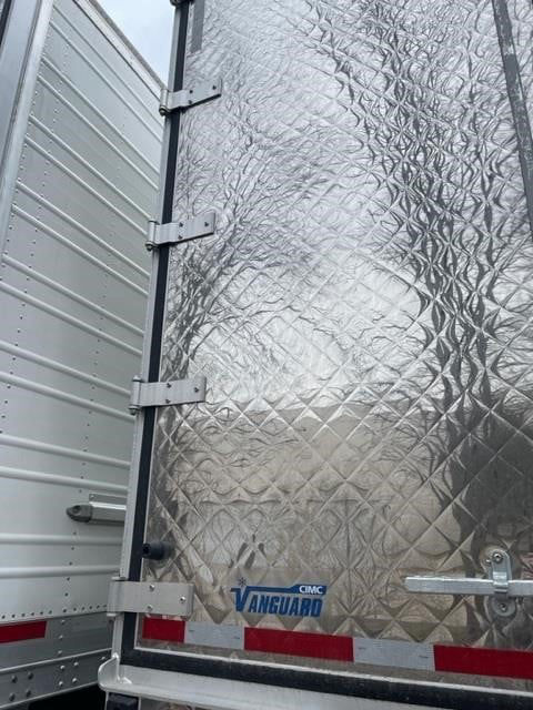 CIMC Vanguard refrigerated trailer rear door with diamond plate exterior and CIMC Vanguard logo visible.