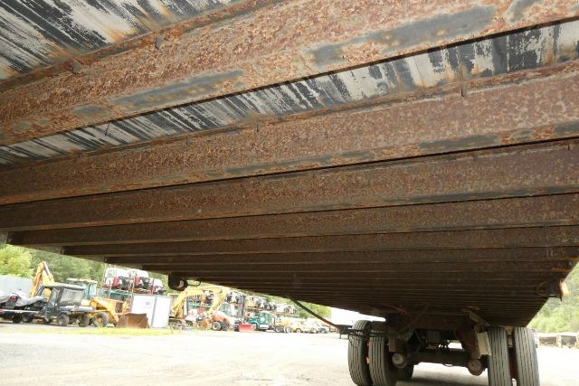Great Dane 7311TP-SAR trailer underside showing rusted I-beam framing and wheels.