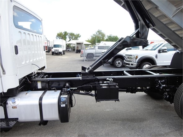 Truck chassis and fuel tank in side view showing frame and hydraulic components.