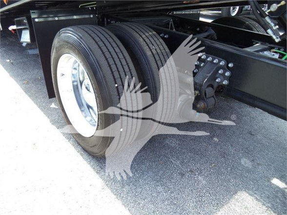 Dual rear tires on a Mack MD6 truck chassis showing wheel rims and suspension components.