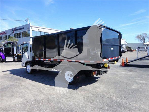 Isuzu NRR dump truck rear/side view with black dump body in a lot.