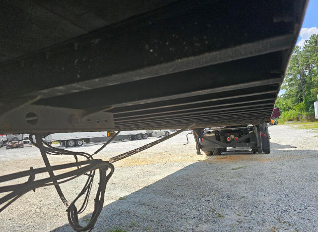 Underframe view of a Vanguard VXP trailer showing electrical cables and hitch area, with the bottom edge of the trailer and support frame.