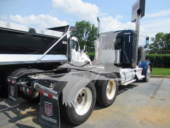 Kenworth W900L truck rear quarter view showing dual rear axles, fuel tanks, and fifth wheel. Visible text on mudflap: TRUCKWORX.