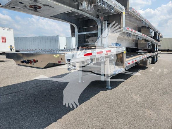Wabash drop deck trailer showing dual-level aluminum frame and landing gear with blue Wabash branding on side.