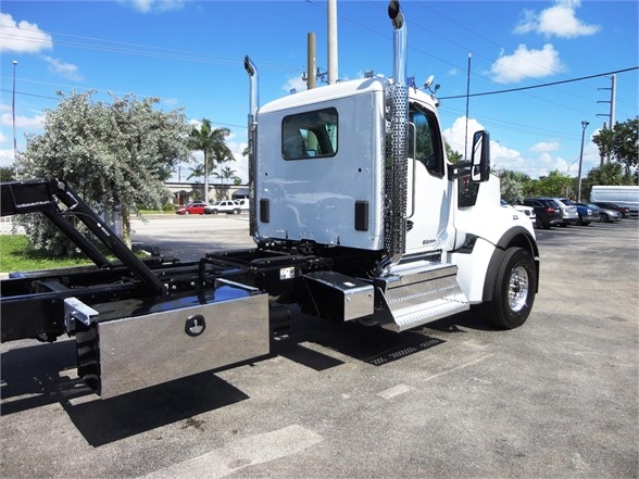 Kenworth W900 side view showing cab and chassis with chrome exhaust stacks and side steps.