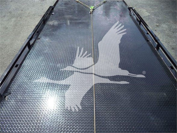 Image shows a metal platform or deck with a bird silhouette watermark. No readable text visible.