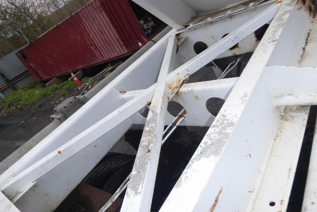 Fruehauf dry bulk trailer frame showing white painted steel beams with surface rust and internal structural members.