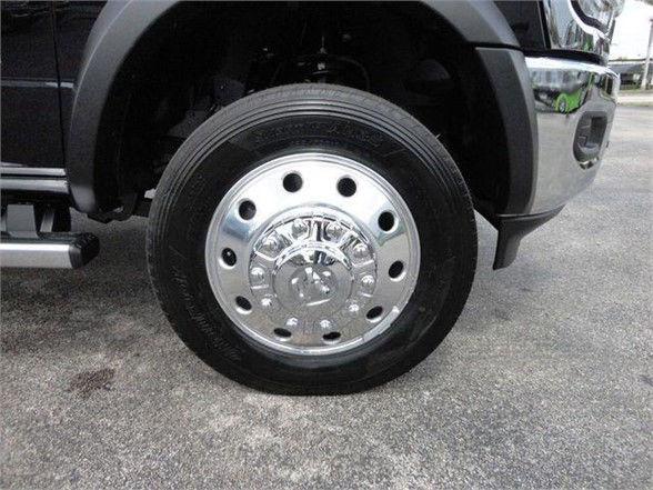 Wheel and tire assembly on a Ram 4500 HD front left, polished hubcap and steel wheel, fender and step visible.