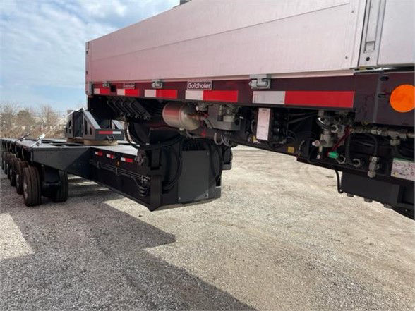 Trailer showing undercarriage and deck of a flatbed with Goldhofer branding and undercarriage components.