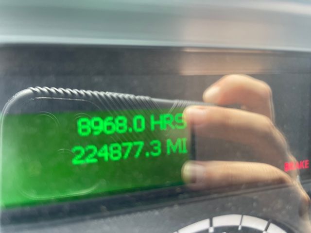 Dashboard display showing 8968.0 HRS and 224877.3 MI on a green backlit screen